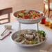 A Choice 2-tier Seafood Tower set with bowls of clams and shrimp displayed on a table.