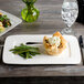 A white Bon Chef rectangular porcelain plate with food on it.