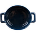 A cobalt blue porcelain oval cocotte with two handles.