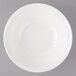 A white Bon Chef porcelain bowl with circles on a gray background.