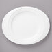 A white Bon Chef porcelain oval salad plate with a curved edge.