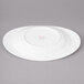 A white porcelain oval salad plate with a round rim.