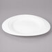 A white porcelain oval salad plate with a concentric design.