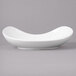 A white porcelain pasta bowl with a curved edge.