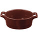 A brown Bon Chef porcelain oval cocotte with handles.