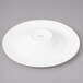 A white porcelain bowl with round concentric circles on the bottom.