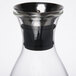 A GET Silhouette glass decanter with a metal lid.