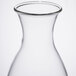 A clear glass decanter with a round neck and a stainless steel lid.
