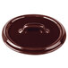 A Bon Chef burnt umber porcelain oval cocotte lid with a handle on a table.