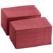 A stack of burgundy paper napkins.