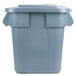 A Rubbermaid grey square trash can with a lid.