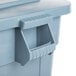 A close up of a Rubbermaid BRUTE gray square trash can with lid.
