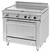 A stainless steel Garland heavy-duty electric range with 2 all purpose top sections and storage base with knobs and a drawer.