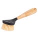 A Lodge scrub brush with black bristles and handle.