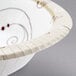 A white Solo paper bowl with a swirl design.