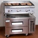 A stainless steel Cooking Performance Group gas radiant charbroiler with two drawers on a counter.