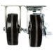 A pair of Vulcan caster wheels with black wheels and white rims.