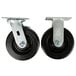 A pair of Vulcan casters with black rubber wheels attached to metal plates.