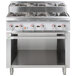 A Cooking Performance Group stainless steel gas range with four burners on top and storage base.