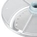 A Robot Coupe 3-disc set for a commercial food processor. A circular plastic object with holes.
