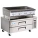A Cooking Performance Group gas countertop griddle with 2 refrigerated drawers.