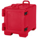 A red plastic Cambro food pan carrier with black handles.