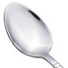 A close-up of a Walco Art Deco stainless steel teaspoon with a silver handle.