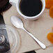 A Walco stainless steel demitasse spoon in a cup of coffee.