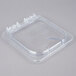 A Carlisle clear plastic lid with a clip on a clear plastic container.