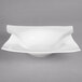 A white porcelain deep bowl with a curved edge.