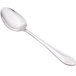 A close-up of a Walco stainless steel serving spoon with a handle.