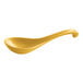 A close-up of a yellow Thunder Group melamine Asian soup spoon with a long handle.