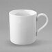 A close-up of a Villeroy & Boch white bone porcelain cup with a handle.