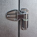 A metal latch on a metal door with a metal hinge.