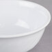 A close-up of a white Thunder Group Melamine Swirl Bowl with a white rim.