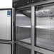 A Turbo Air M3 Series stainless steel reach-in freezer with half doors and shelves.