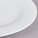 A white Thunder Group oval melamine platter with a small amount of food on it.