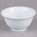 A close up of a white Thunder Group Imperial melamine rice bowl.