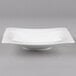 A Villeroy & Boch white bone porcelain deep plate with a curved edge.