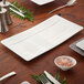 A table set with Villeroy & Boch Modern Grace white bone porcelain rectangular plates and utensils.
