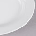 A close up of a white Thunder Group oval melamine platter with a white rim.
