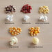 A group of Amish Country Red Butterfly Popcorn kernels, including a variety of popcorn sizes and flavors.
