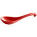 A red spoon with a long handle.