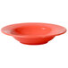 A close-up of a red Thunder Group melamine bowl with a wide rim.