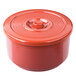 A red plastic circular rice container with a lid.