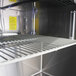 A Turbo Air stainless steel shelf in a refrigerated sandwich prep table.