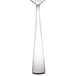 A silver Walco Freya teaspoon with a white handle.