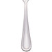 A silver demitasse spoon with a white background.