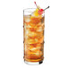 A Libbey Specialty Cooler glass of iced tea with ice and a cherry.