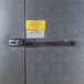 A Norlake Kold Locker metal door with a sign on it.
